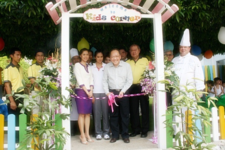 Supachayanont cuts the ribbon during the opening of the Kids Corner.